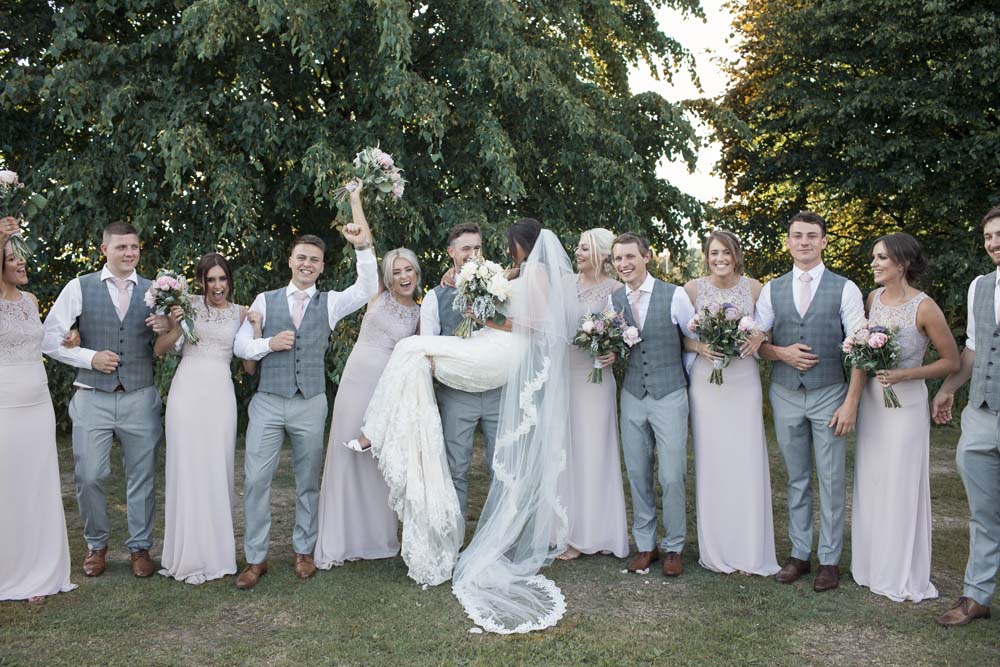 Bridesmaids and groomsmen celebrating the bride and groom having fun DIY wedding Preston Lancashire