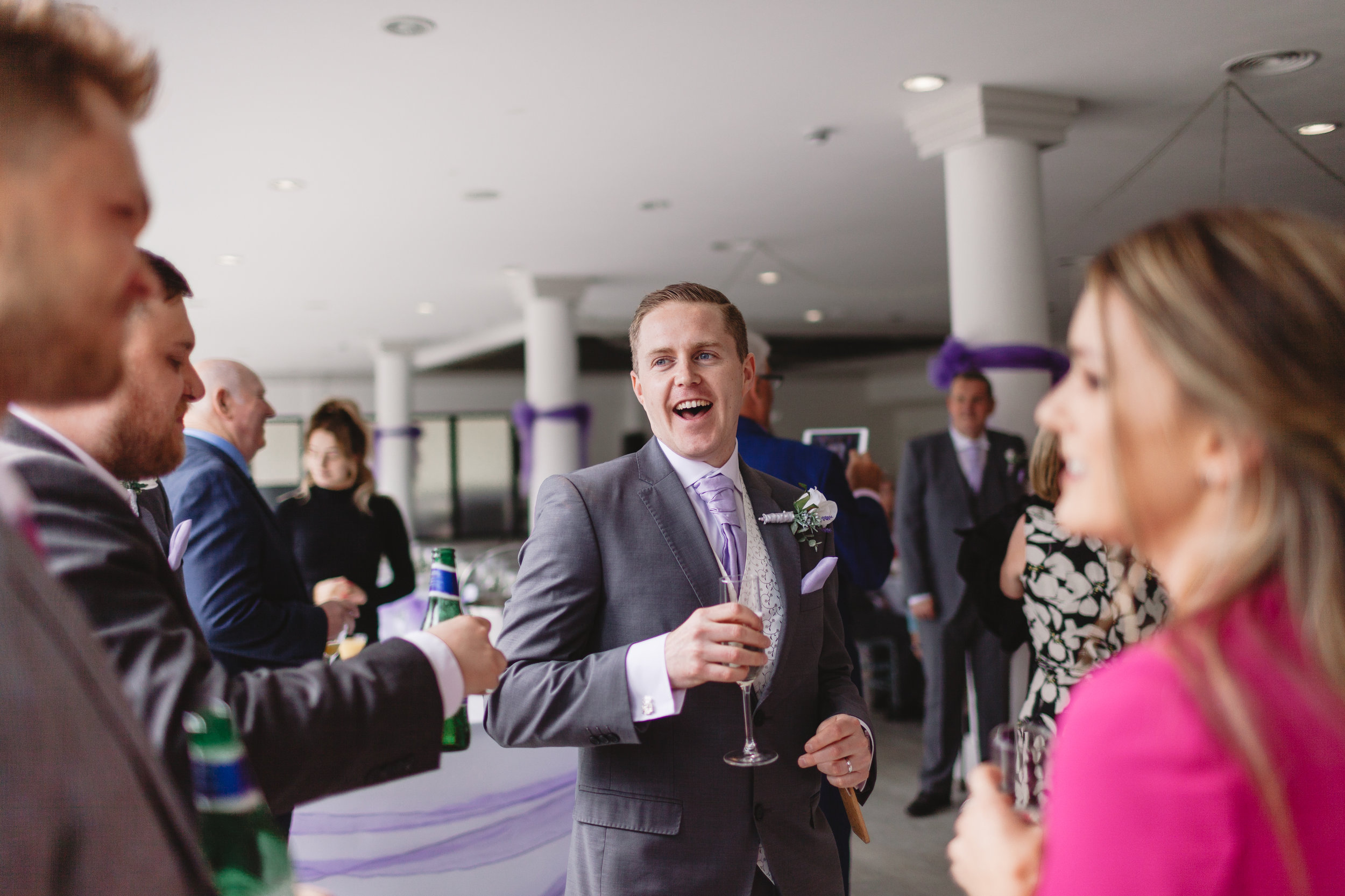 Groom laughing on his wedding day being photographed huddersfield