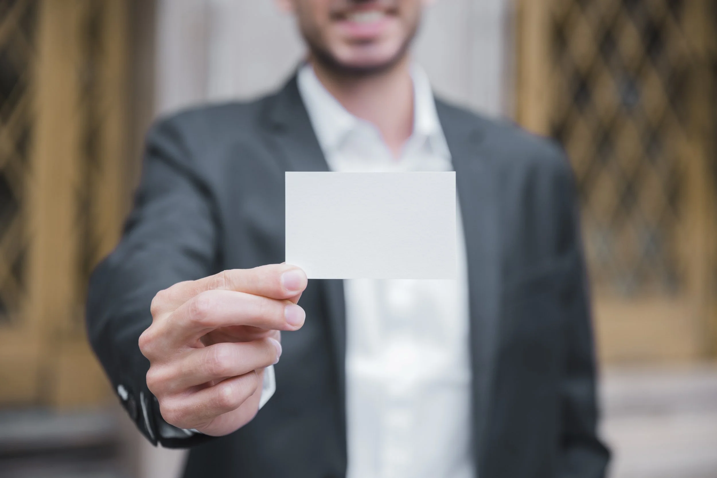 close-up-young-businessman-showing-white-visiting-card-front-camera.jpg
