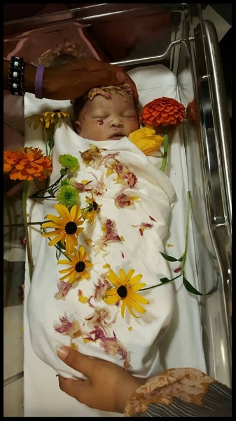 Kali Ra swaddled and surrounded with love, moments after transition.