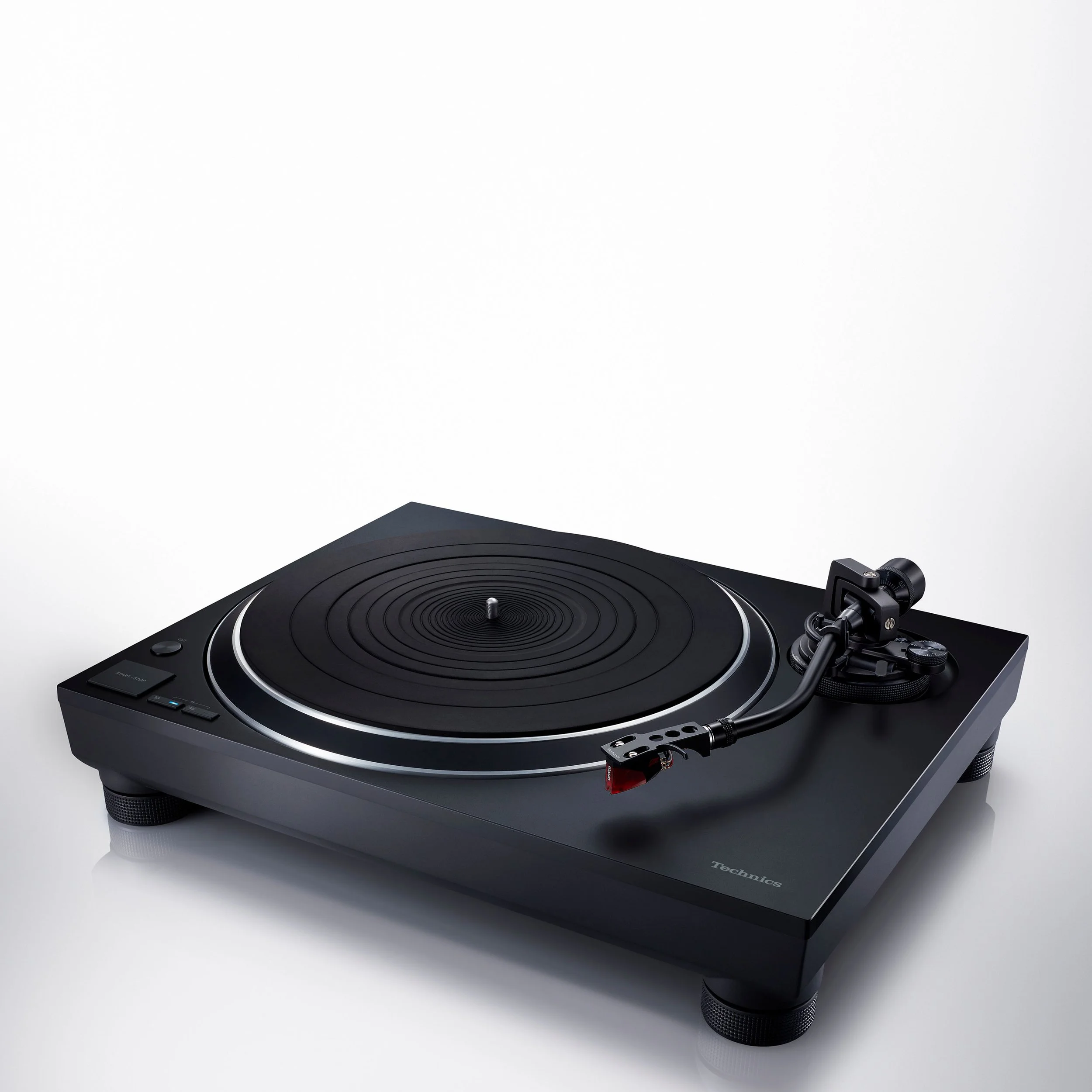 Angled view of the Technics SL-1500C direct drive turntable in black.