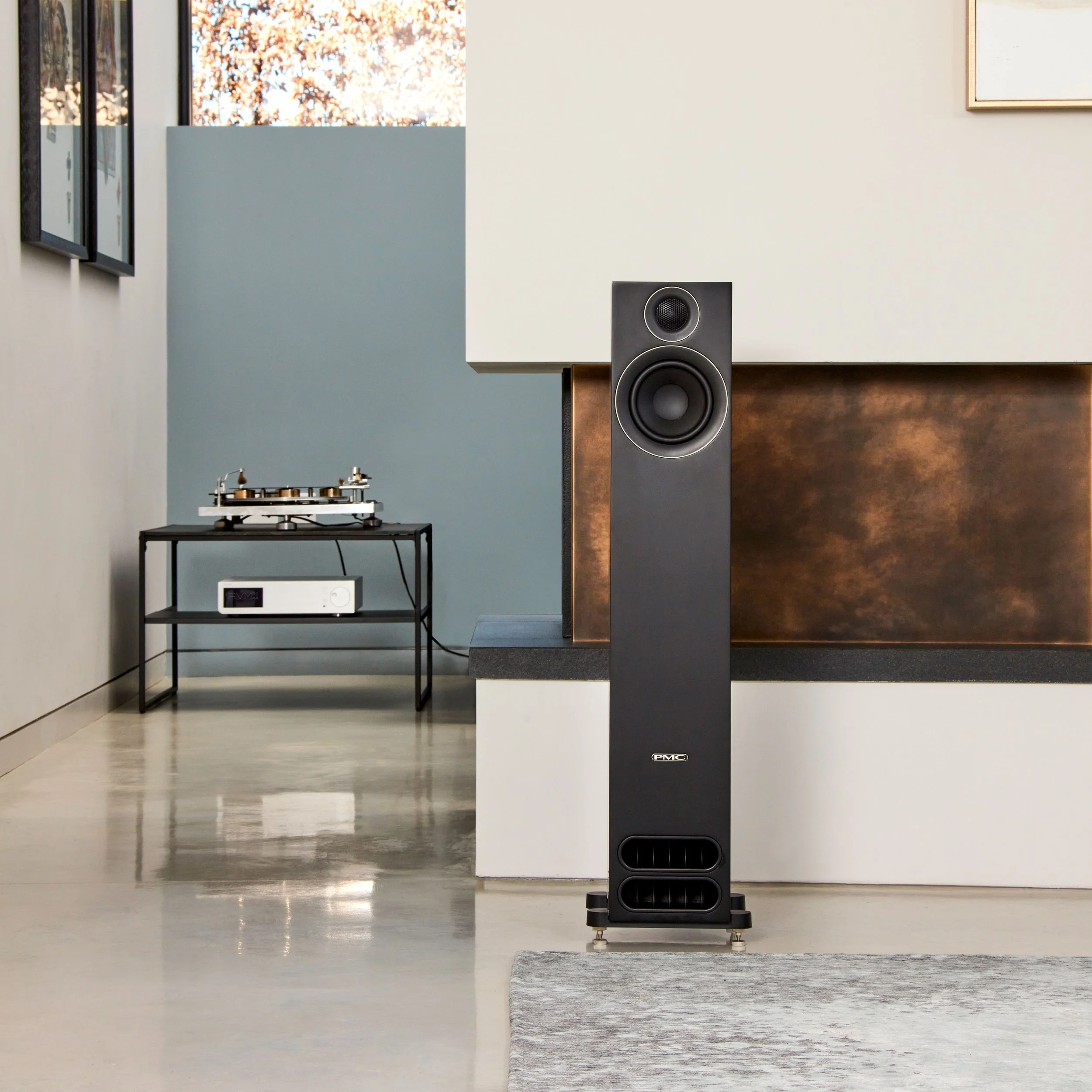 A PMC prodigy5 floorstanding speaker pictured in a contemporary living space.