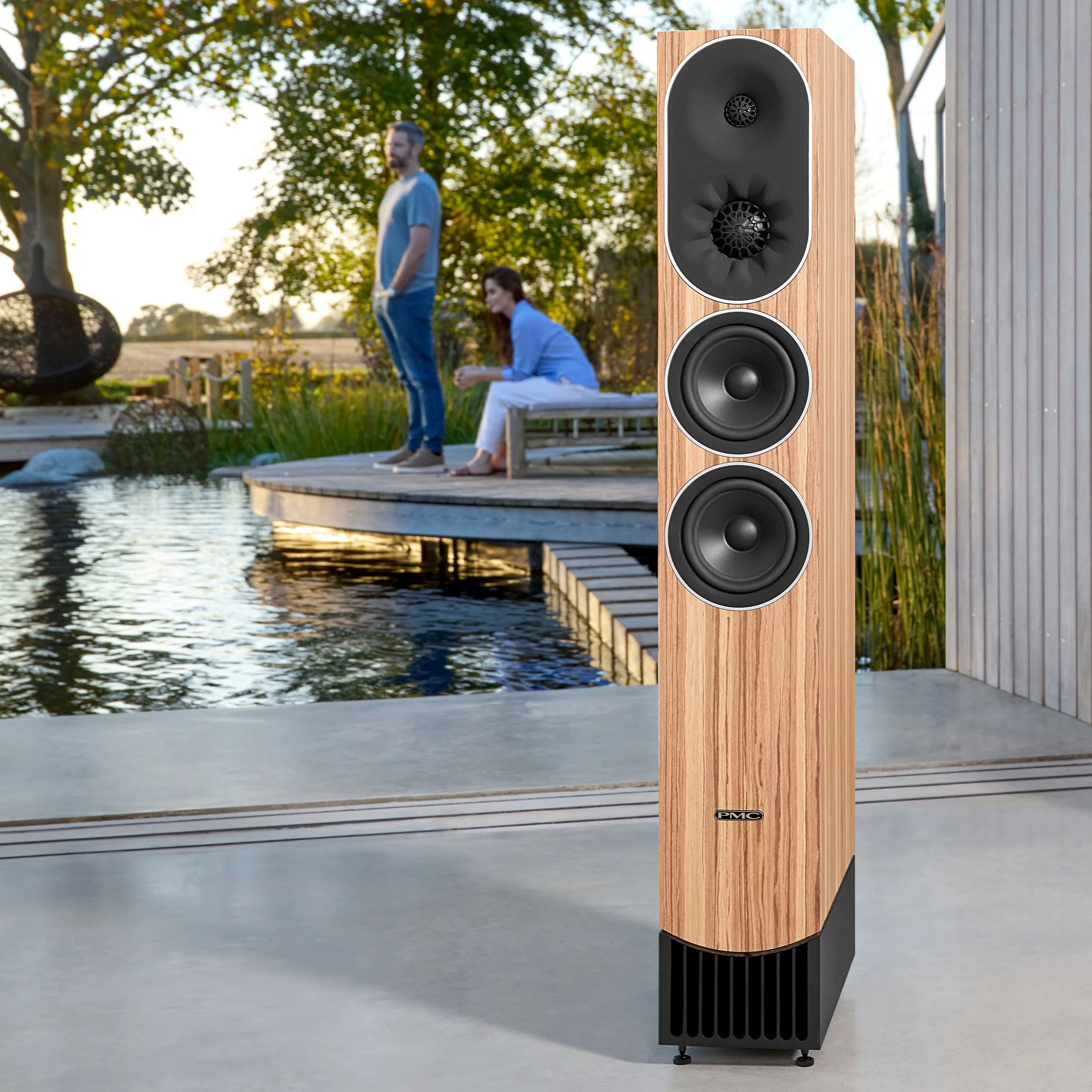 Lifestyle image of the PMC prophecy9 floorstanding speaker shown in Mediterranean Oak.