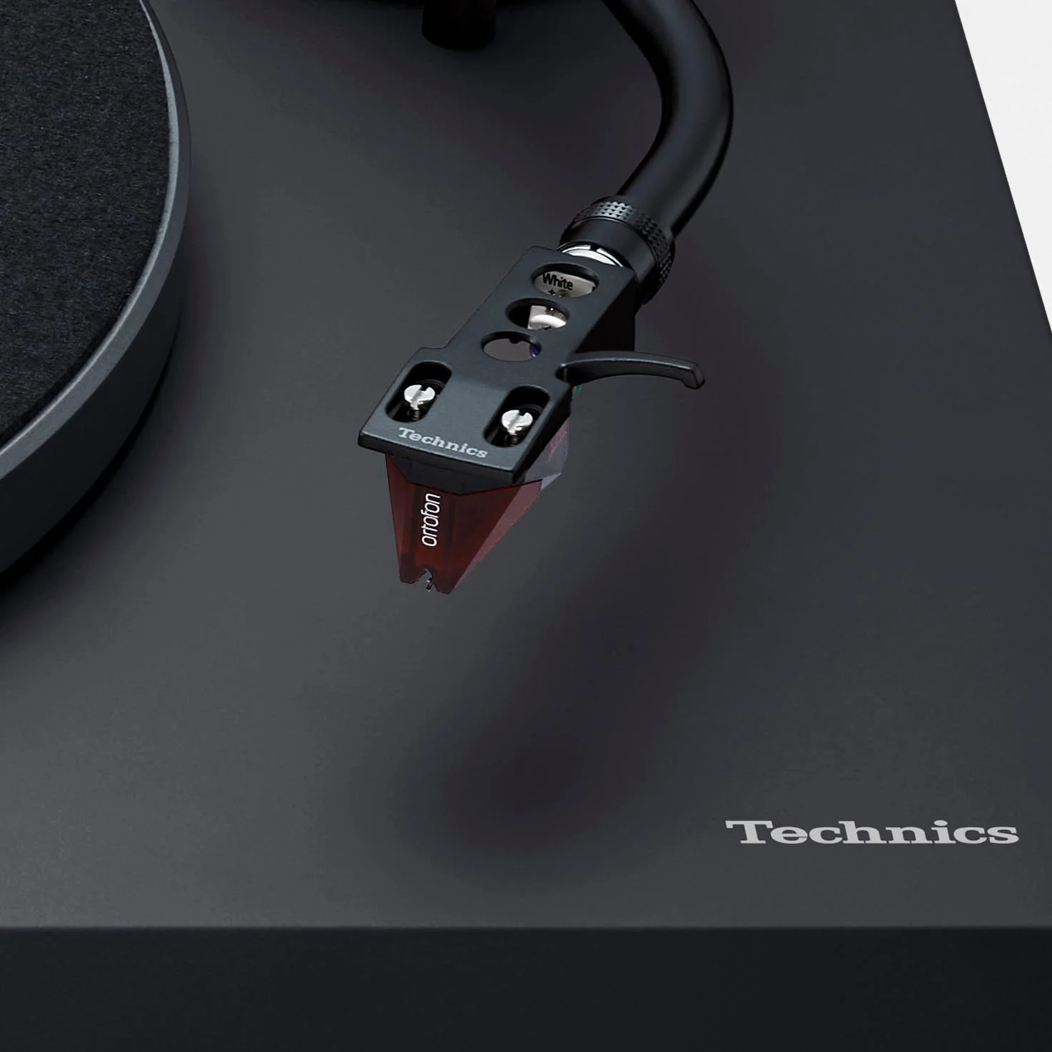 Close-up detail of the Ortofon 2M red cartridge installed on the Technics SL-50C.