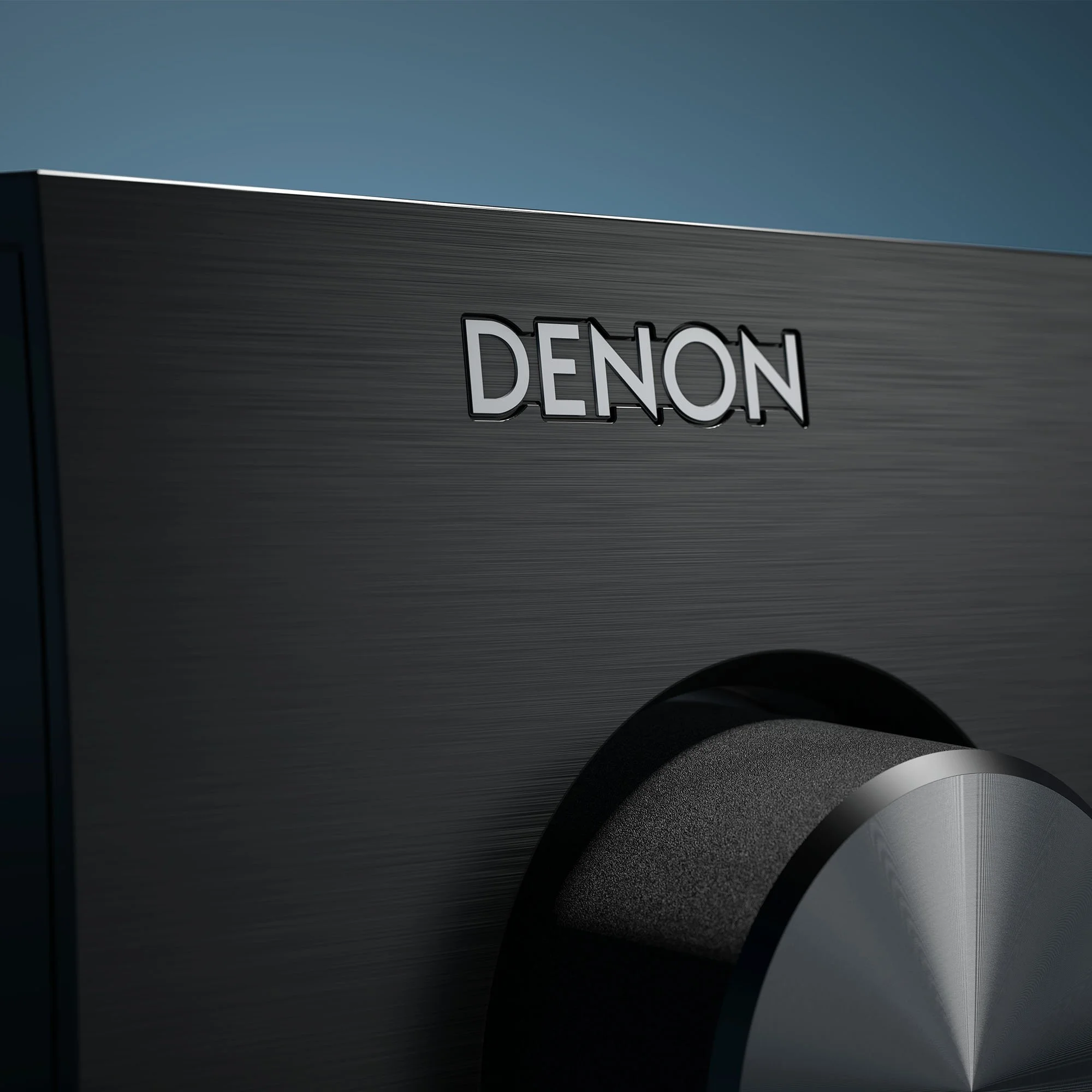 Close-up detail of the logo on a Denon AV surround receiver.