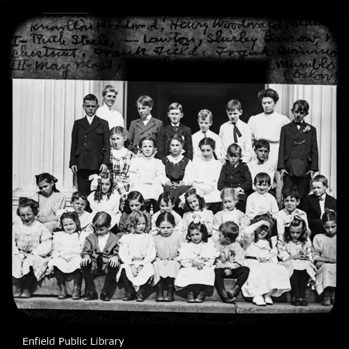 Here is the Junior Department and the Primary Department, or more truly, as many of them as we could get together for the picture. I will give names from left to right, beginning with the back row.Teachers Present: Miss Mary Parsons. Supt. of the Primary; and Lillian Pease, a teacher.Edward Kingsbury, Fred Simmons, Knowlton Woodward, Henry Woodward, Stanley Adams.Ruth Steele, Miss Lawton, Shirley Garrow, Nellie Chestnut, Frank Field, Frank Simmons,Mary Most, Joseph Mayo, Pearl Mumblo, Charlotte Most, Roy Anderson, Gertrude Whittaker, Marion Jones, Norman Henry, Willie Edgar.Esther Steele, Louise Edgar, John Brown, Doris Field, Laura Burbank, Lillio Most, George Burbank, Maude Frazier, Lillian Brown, Alma Most.