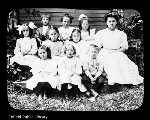 Let us name them from left to right, beginning with the back row.John Brown, Esther Steele, Maude Frazier, Miss Lillian Pease(the teacher).Marion Leete, Anna Most, Louise Edgar.The front row I cannot name.