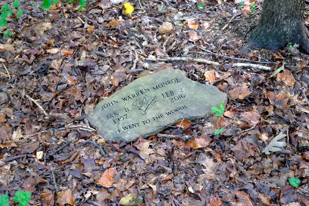 The woods are a lush place, a cool damp resting spot where a more recent burial than Clark's bears the inscription, "I went to the woods."