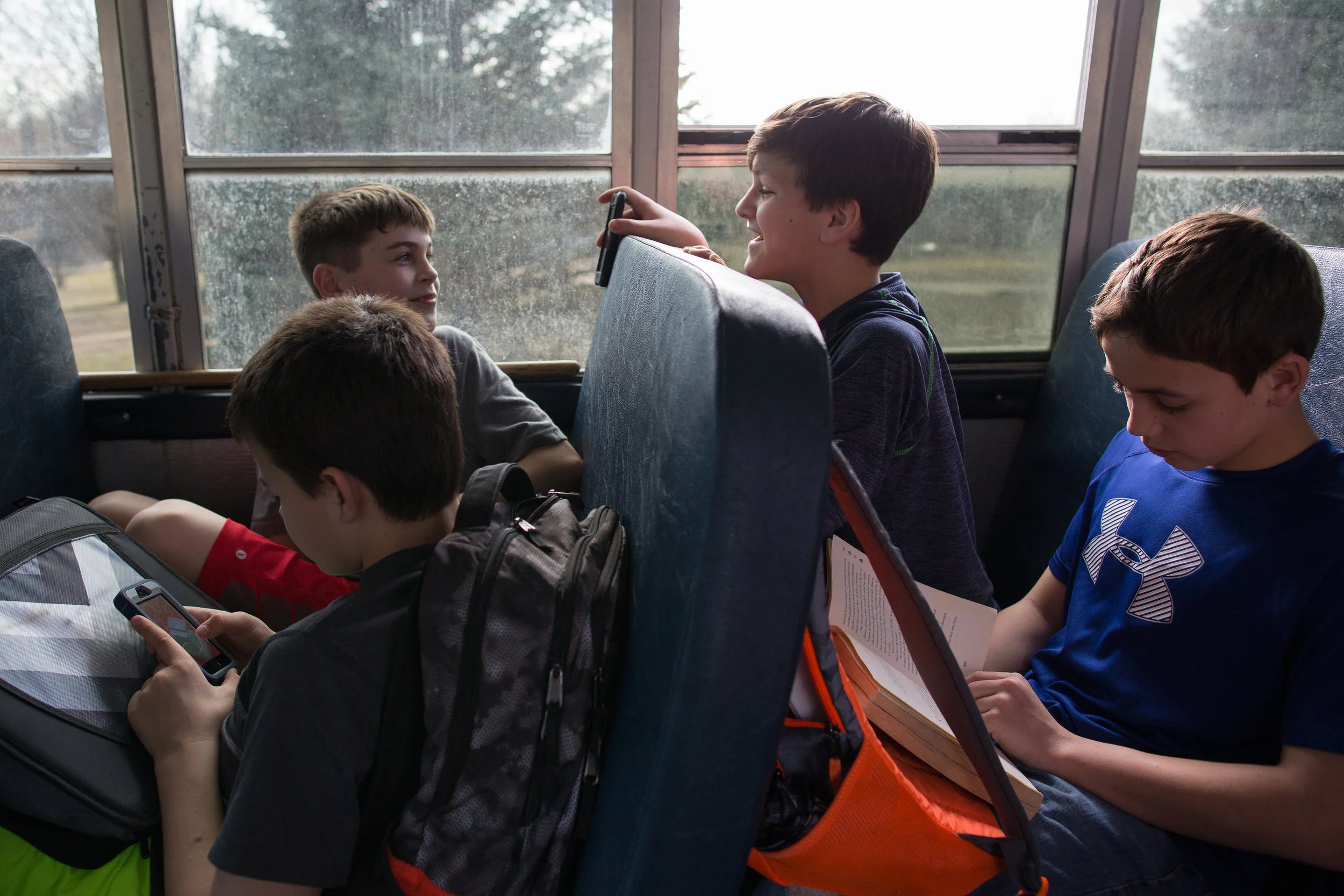 Hayden Taylor, Connor Patrick, Tyler Hancox, and Luke Luu (left to right) ride the bus home from school in Solon, Iowa on Tuesday, March 8, 2016.