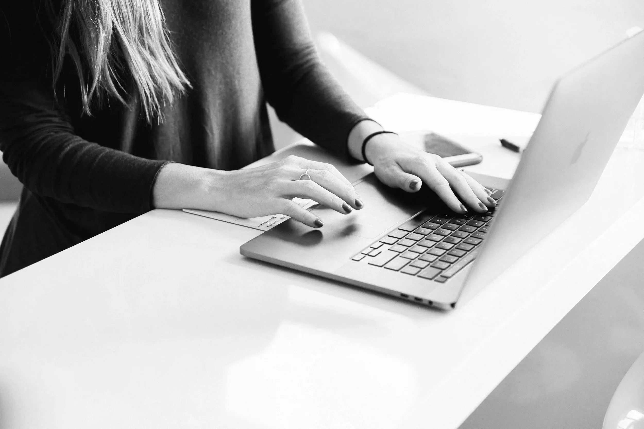 Woman writing on a laptop