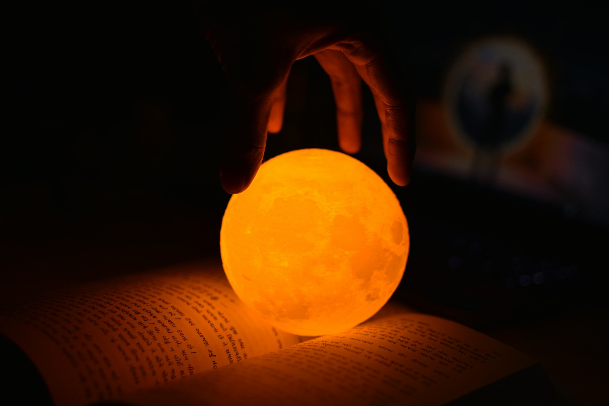Moon globe illuminating a piece of intuitive writing in a book