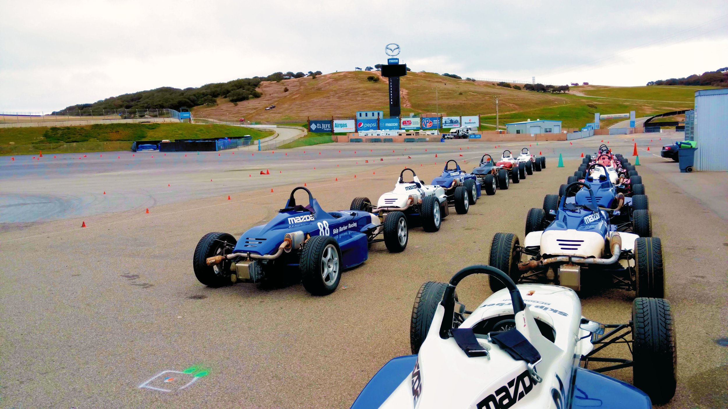 Skip Barber Formula cars lined up in the paddock