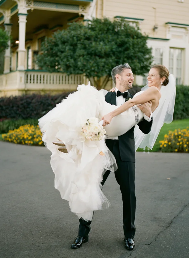 32-groom-holds-bride-threshold.jpg