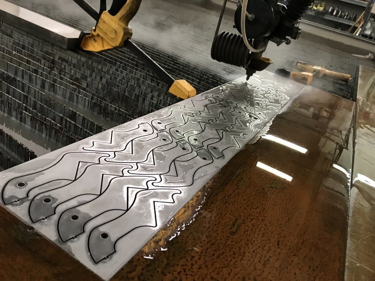 waterjet cutter cutting a sheet of metal shear blades.JPG