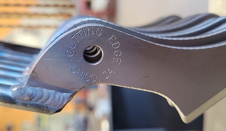 up close pic of the inscription of a pair of shears that reads cutting edge chico, CA.jpg