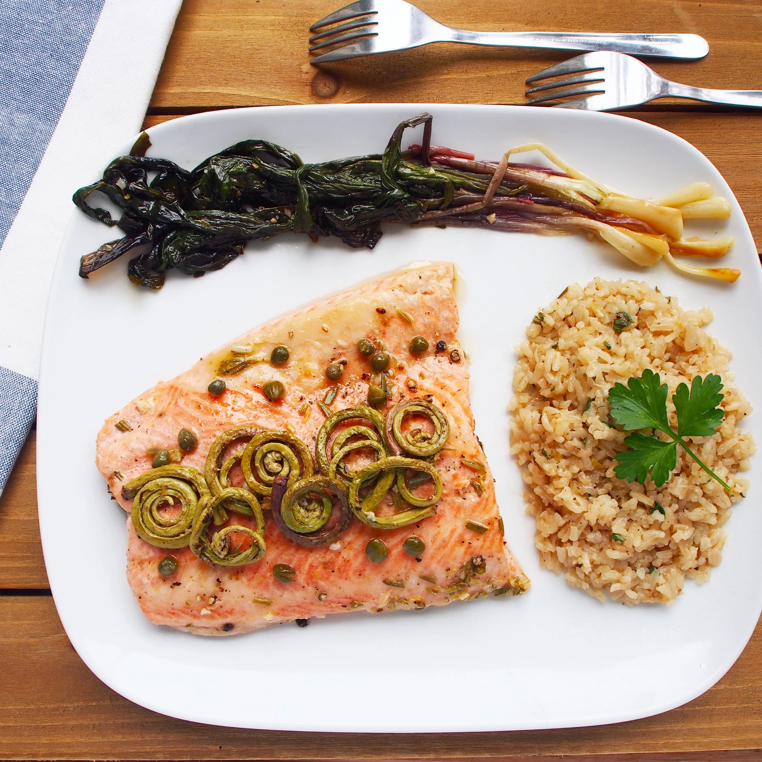 This broiled steelhead trout recipe is broiled with wild fiddleheads and ramps, a.k.a. wild leeks. 