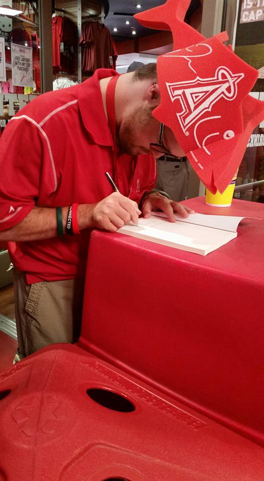 Trevor signing Angel for Higher at Angel Stadium.