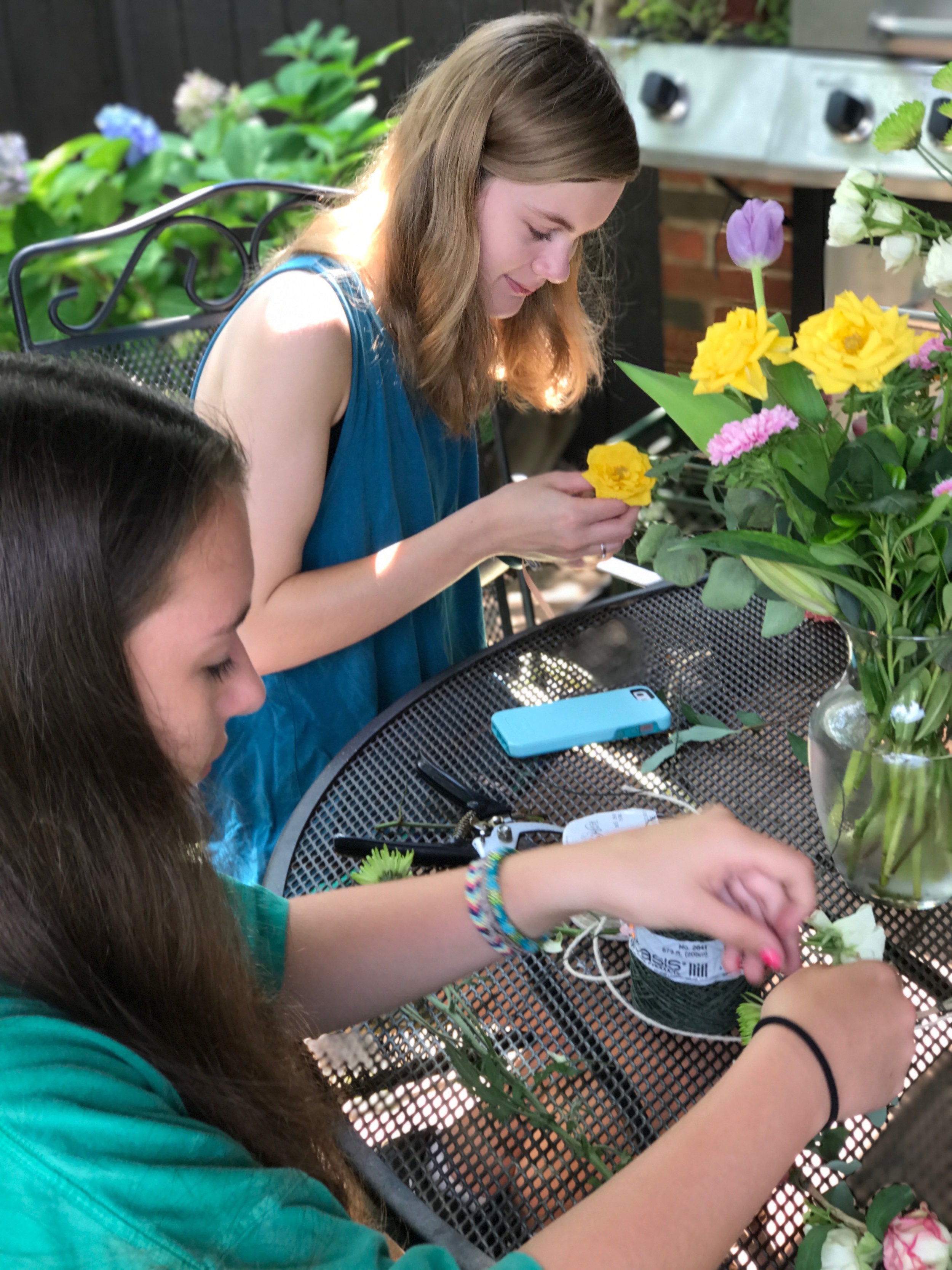 These girls are working hard on some flower crowns!