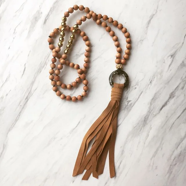 This one-of-kind Rock &amp; Lulu necklace blends elements of wood, suede and crystal for a unique city/country chic vibe. 
#rockandlulu #jewelry #jewelrydesigner #necklace #oneofakind #suedetassel #rosewood #beads #crystal #swarovski #modernandclassi