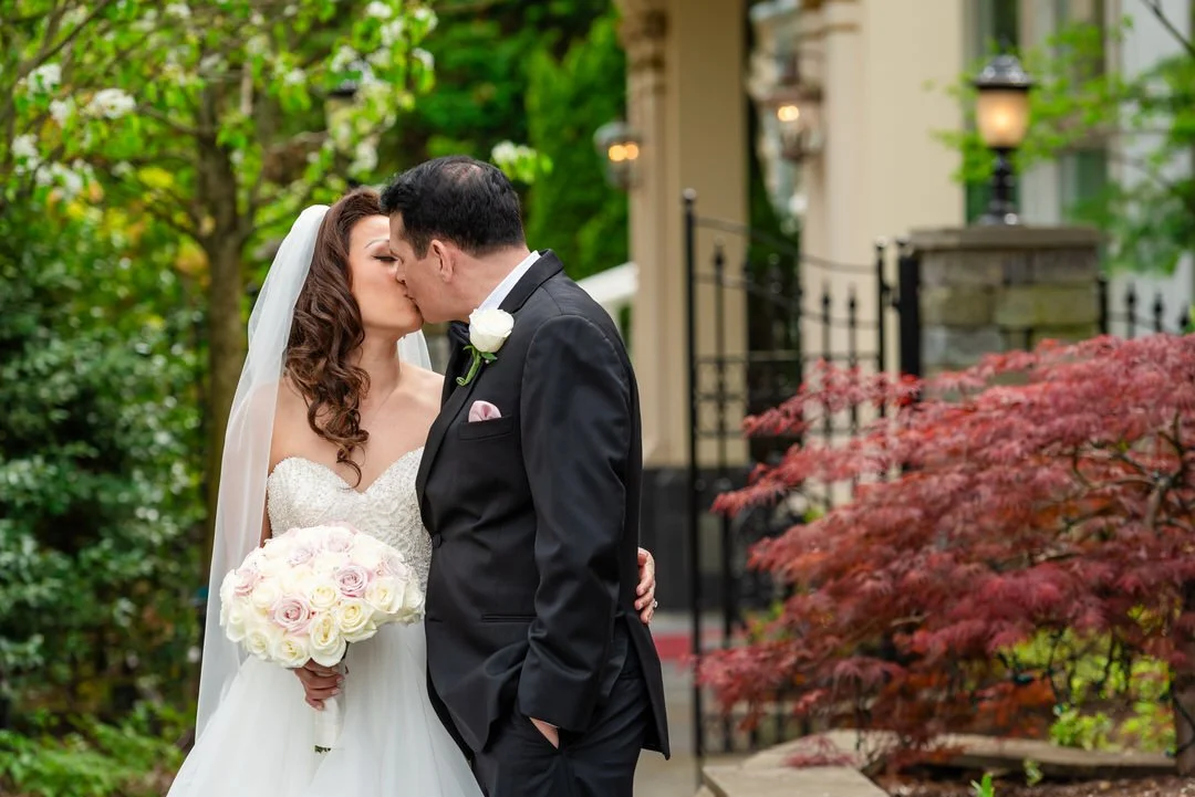 Bride and groom sharing a romantic moment outside Westmount Country Club in Woodland Park NJ.