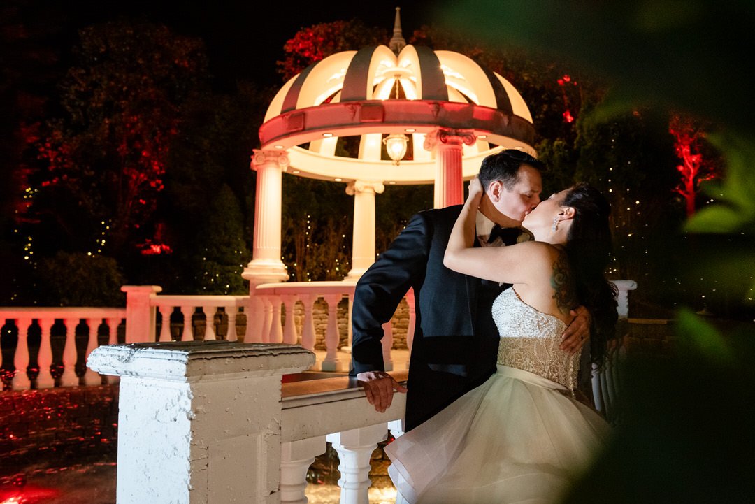 Romantic nighttime wedding portrait at the illuminated gazebo at Westmount Country Club.