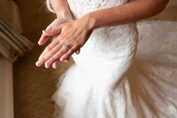 Bride showing her engagement and wedding rings