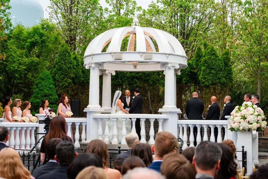 Outdoor wedding ceremony under the white gazebo at Westmount Country Club.