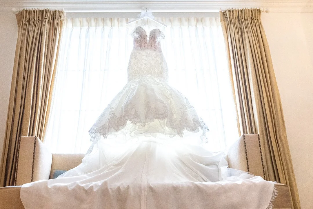 Wedding dress hanging by the window at a Cedar Grove wedding venue