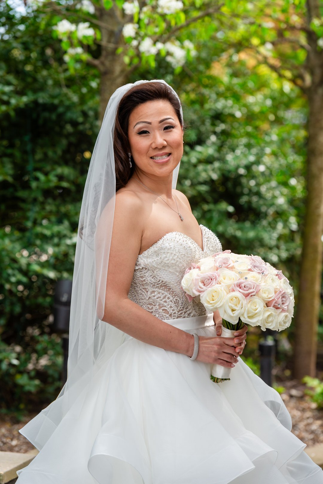 Bride holding her bouquet in a classic wedding gown at Westmount Country Club.