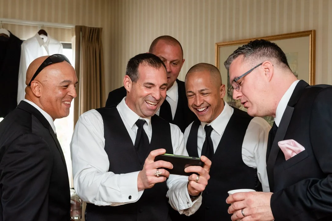 Groom and groomsmen laughing and getting ready before the ceremony at Westmount Country Club.