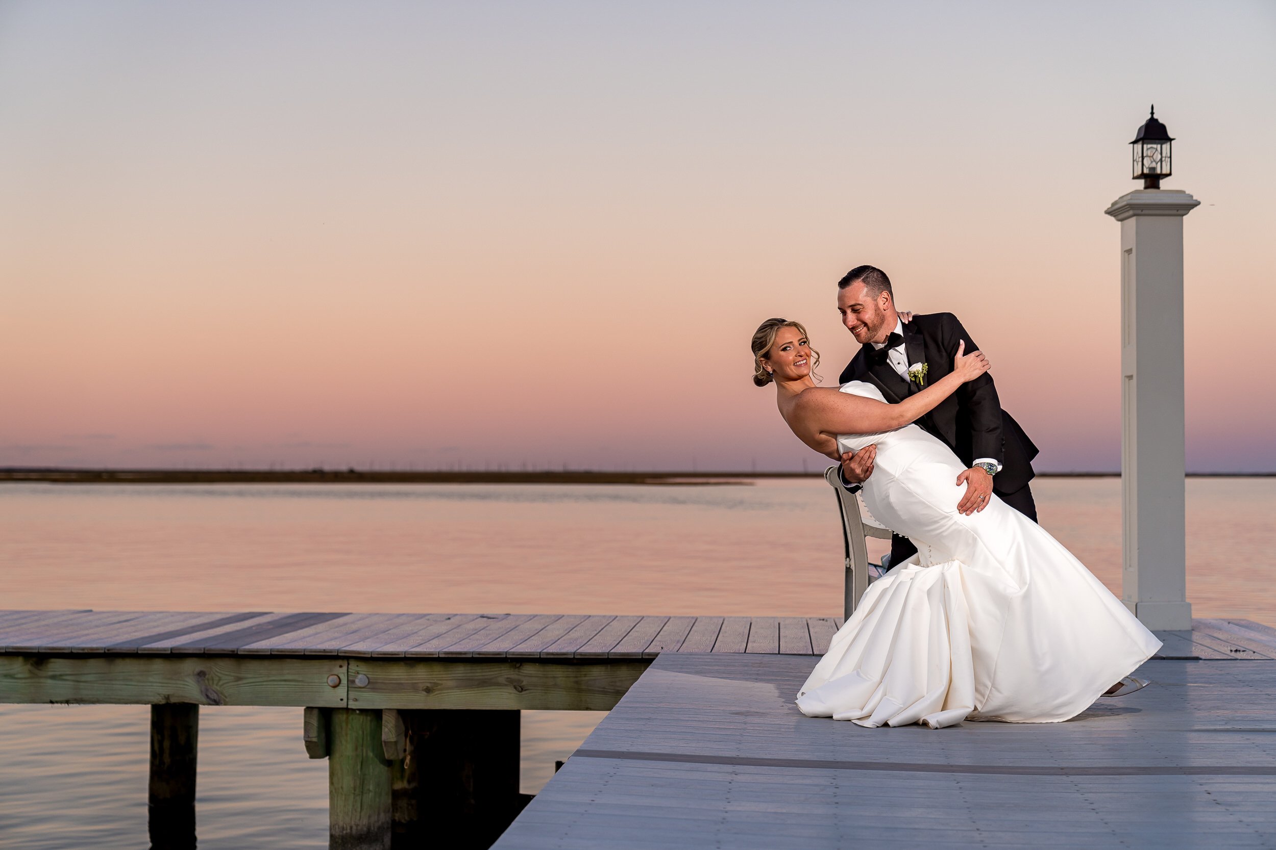 Mallard Island Yacht Club wedding photographer Bride and groom posing on the dock at sunset at Mallard Island Yacht Club in New Jersey