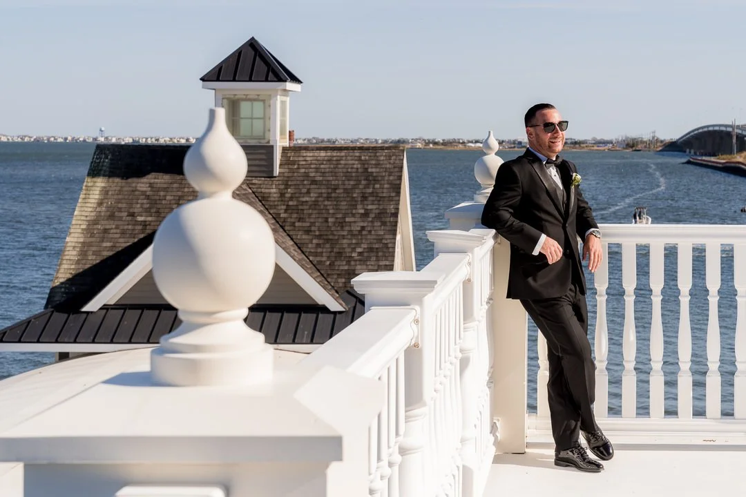 Groom portrait overlooking the water at Mallard Island Yacht Club in New Jersey