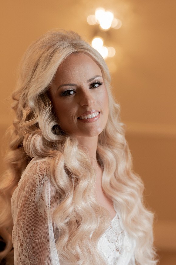 Bridal portrait showing soft makeup and curls before the wedding