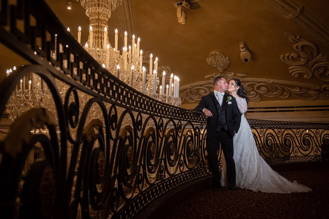 Bride and groom portrait under chandeliers at The Venetian wedding venue in Garfield, NJ.