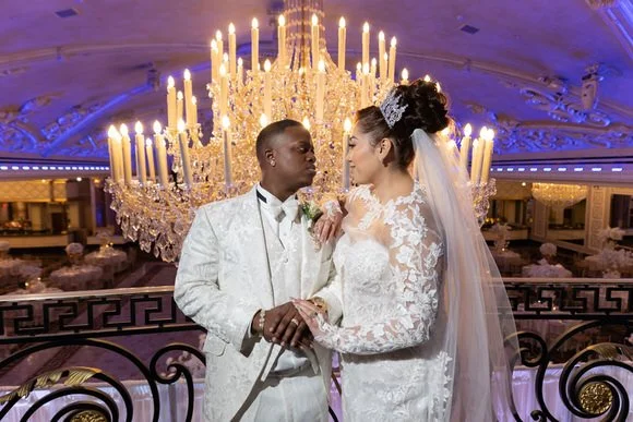 Couple portrait with chandelier backdrop at The Venetian wedding venue in Garfield, NJ.