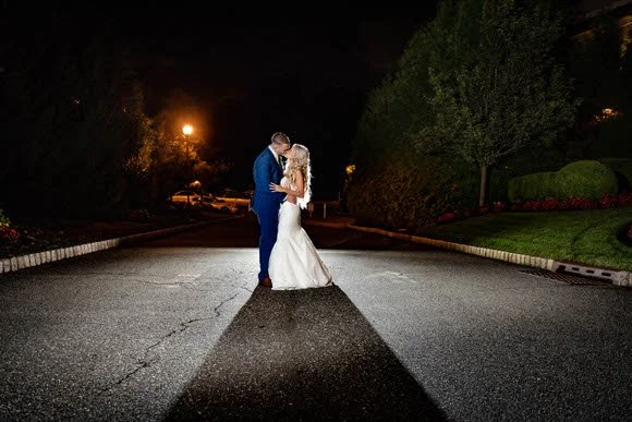Bride and groom posing for romantic night portrait outside The Grove