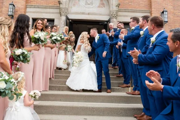 Wedding party celebrating together outside the church