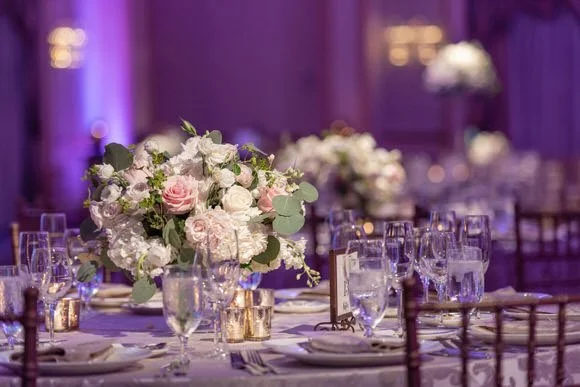 Floral arrangements and reception décor in soft candlelight