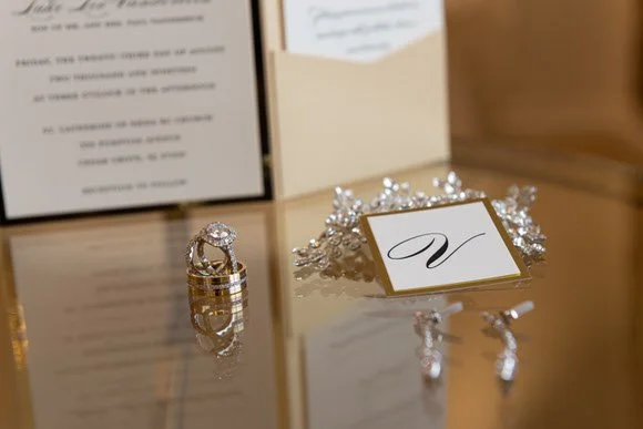 Elegant wedding rings and invitation details photographed by Jason Giordano Photography