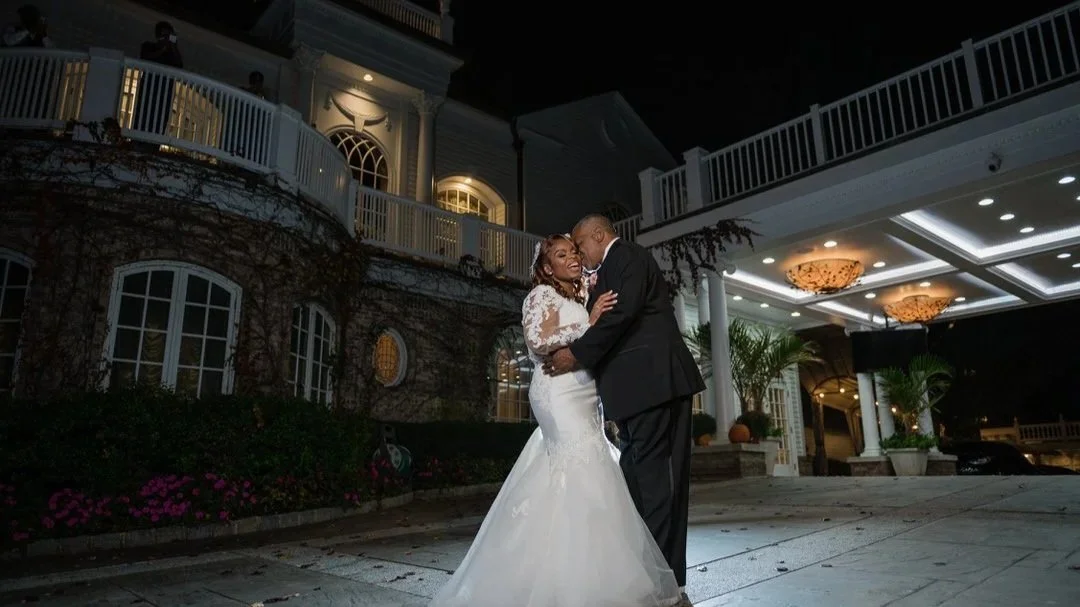 Nighttime couple portrait outside entrance of The Brownstone venue