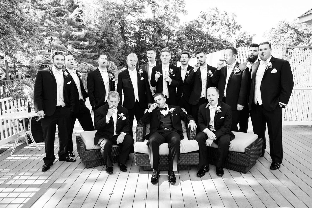 Groom and groomsmen posing together during a wedding celebration at The Tides in New Jersey