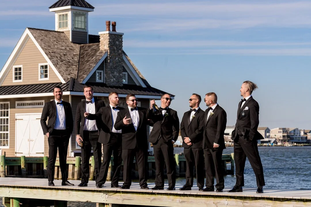 Wedding party gathered along the waterfront at Mallard Island Yacht Club before the ceremony