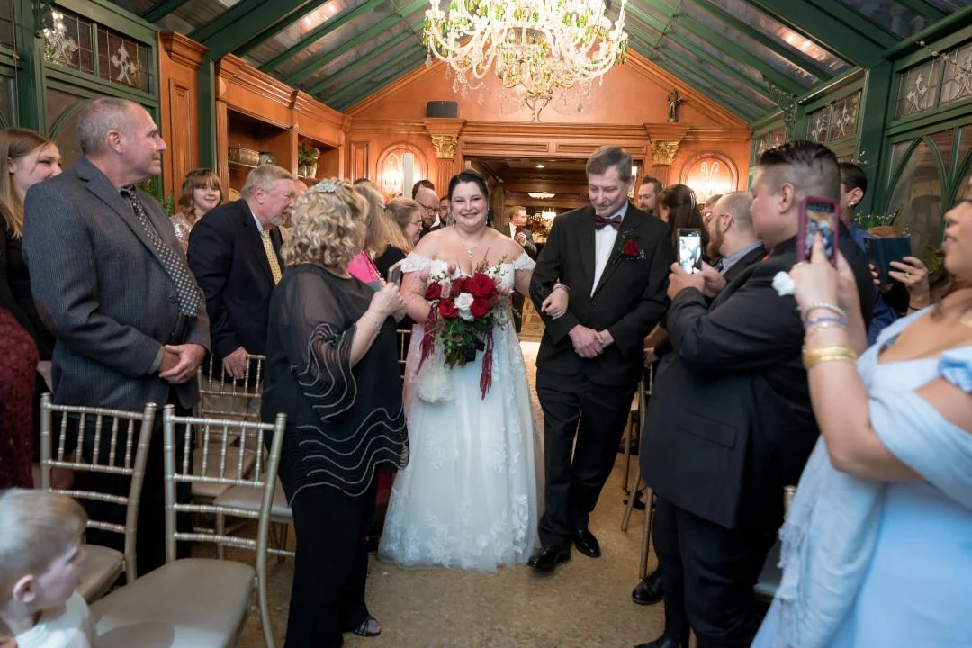 Bride walking down aisle during indoor ceremony at The Brownstone
