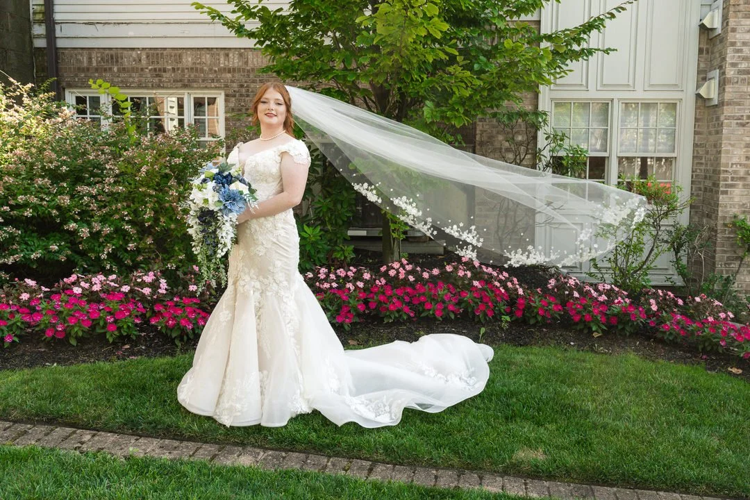 Bride posing with bouquet and veil in garden at The Brownstone NJ