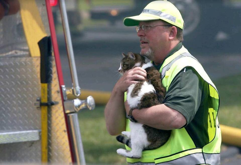  On May 24 2015,&nbsp;East Side Fire responded to a fire in a 16-unit apartment complex. Pictured is Chaplain Coons safeguarding a pet rescued from the fire. Photo credit Belleville News Democrat 