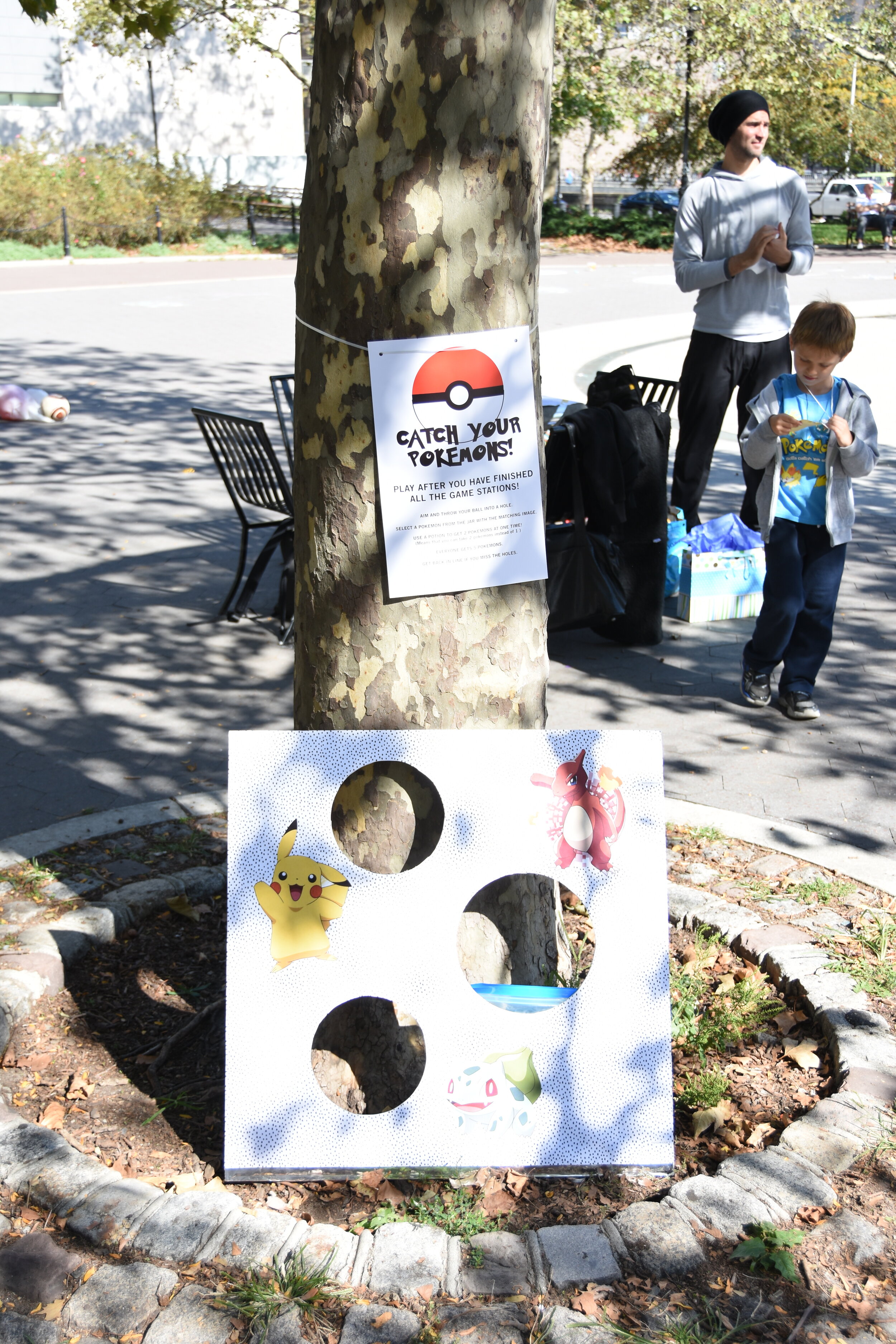  I covered a cardboard sheet with wrapping paper and print outs of pokemons. Kids had to throw their red plastic ball into a cut out space to be able to ‘catch’ their mini pokemon figures. 