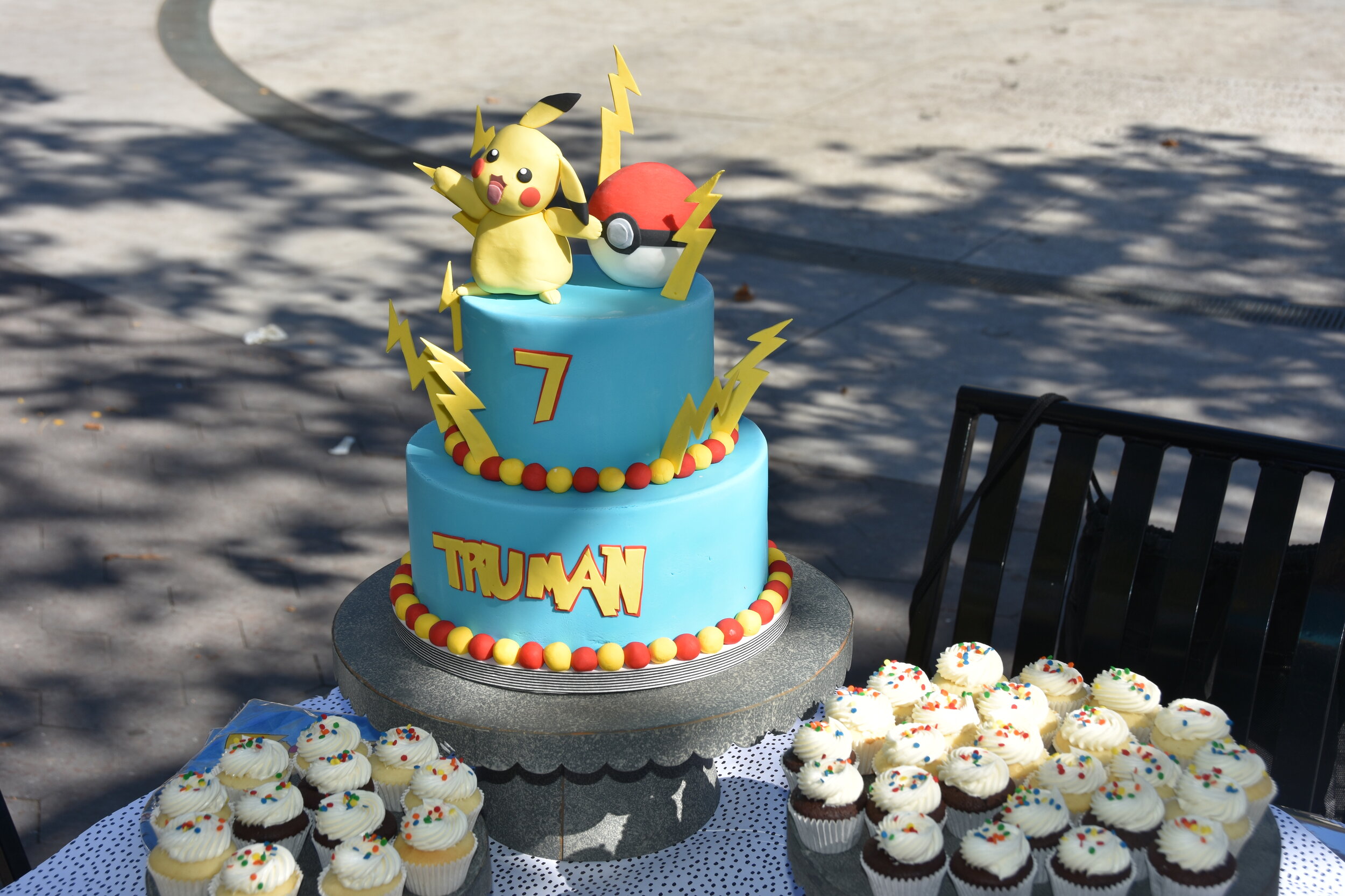  Ninecakes made a custom Pokemon themed cake and mini cupcakes. 