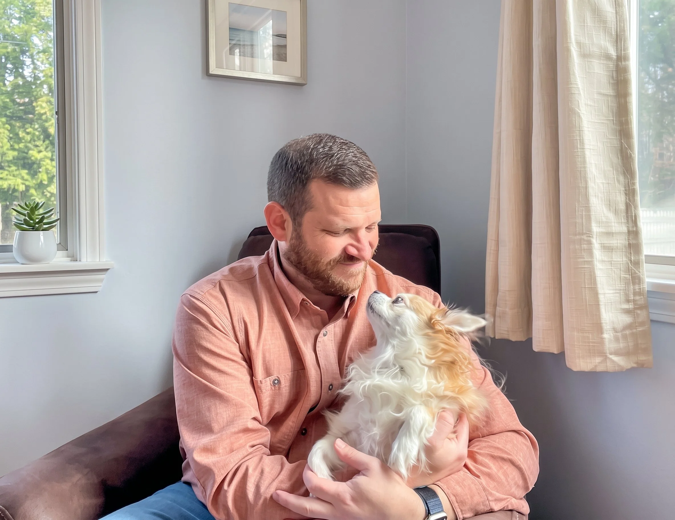 Dr. Jared Leaderman seated with his dog
