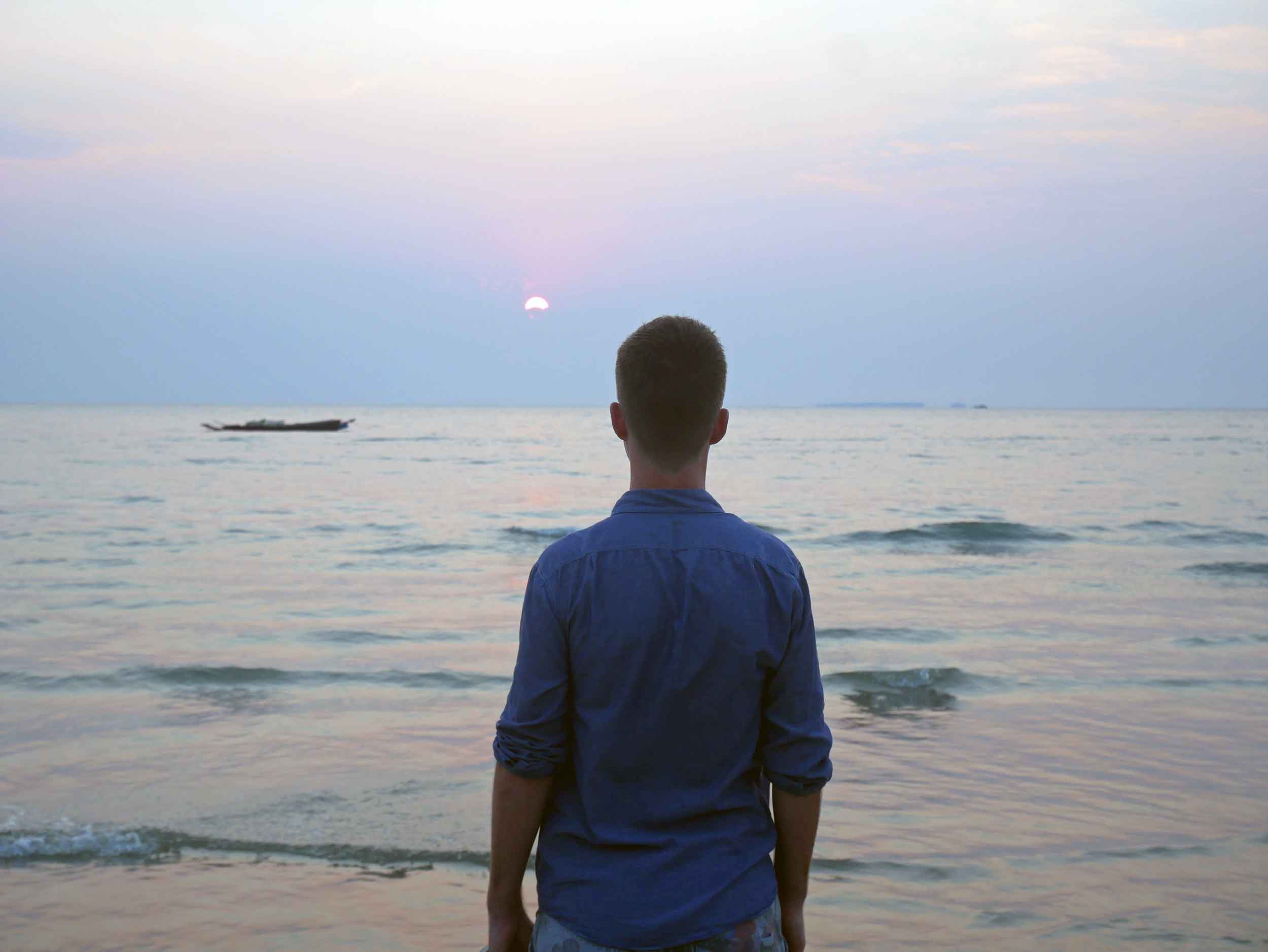  Trey taking in the breathtaking sunset of Ngwesaung, where the sun disappears before it hits the horizon.&nbsp; 