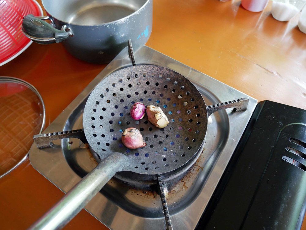  We started with making the Pho beef broth, which needs several hours to simmer. A key step is to char the shallots and ginger for rich flavor in the broth.&nbsp; 